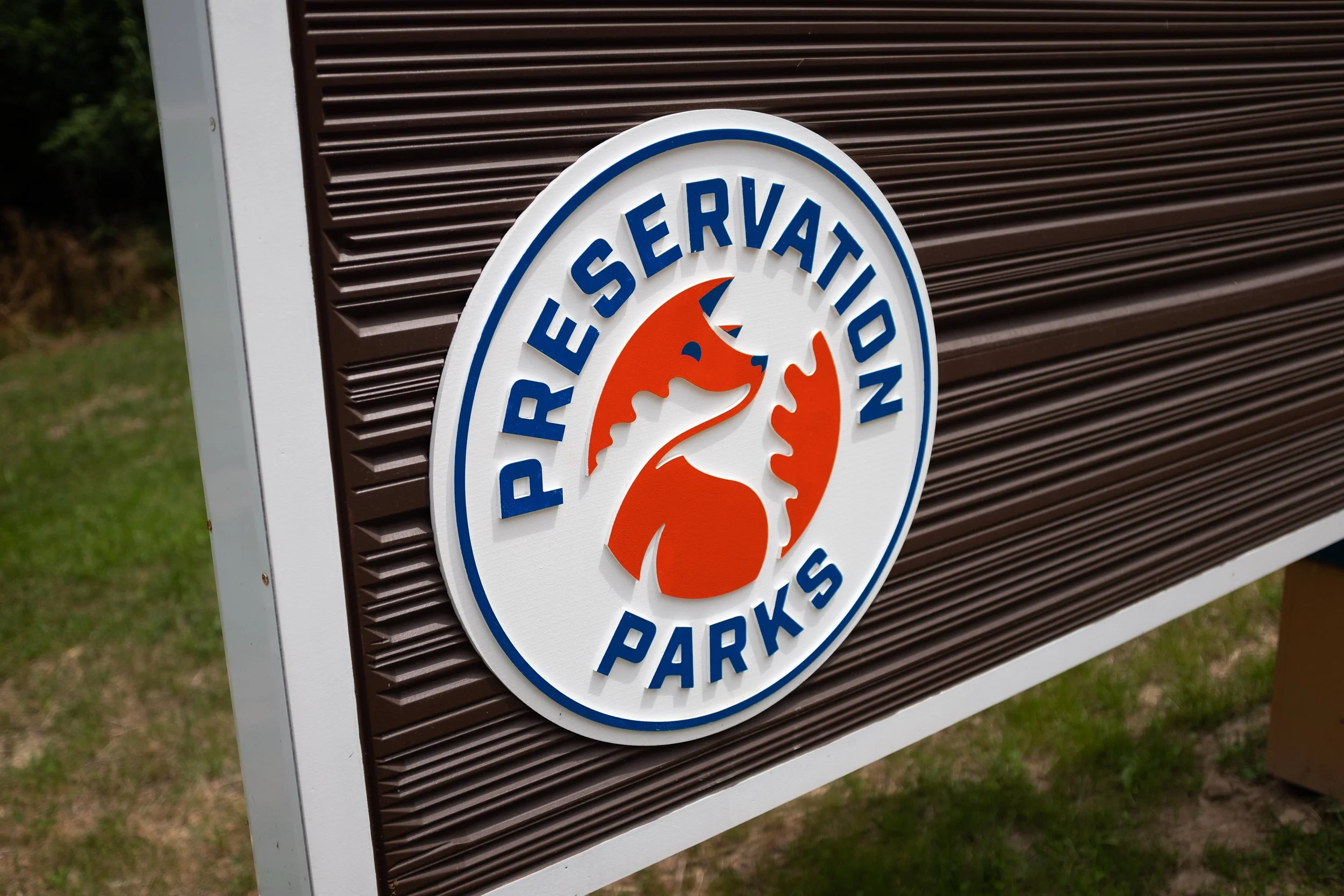Signboard for a nature reserve park with a logo of a fox and the text "PRESERVATION PARKS".