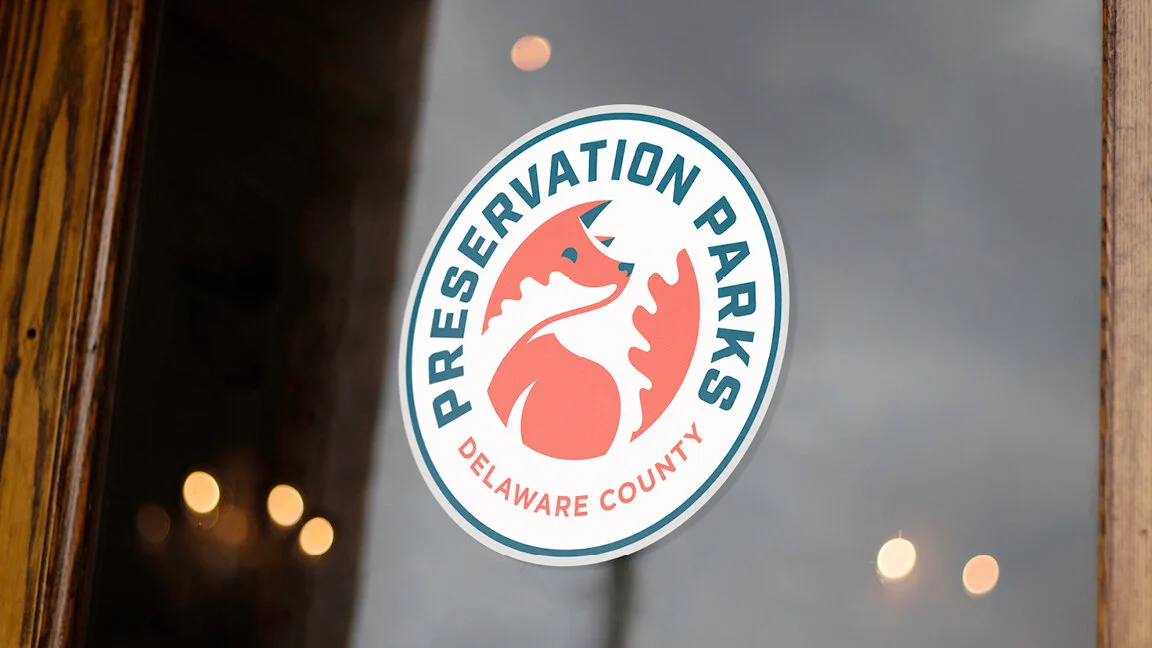 Preservation Parks of Delaware County logo sticker on a glass door or window featuring a stylized seahorse and the text 'Preservation Parks Delaware County'.