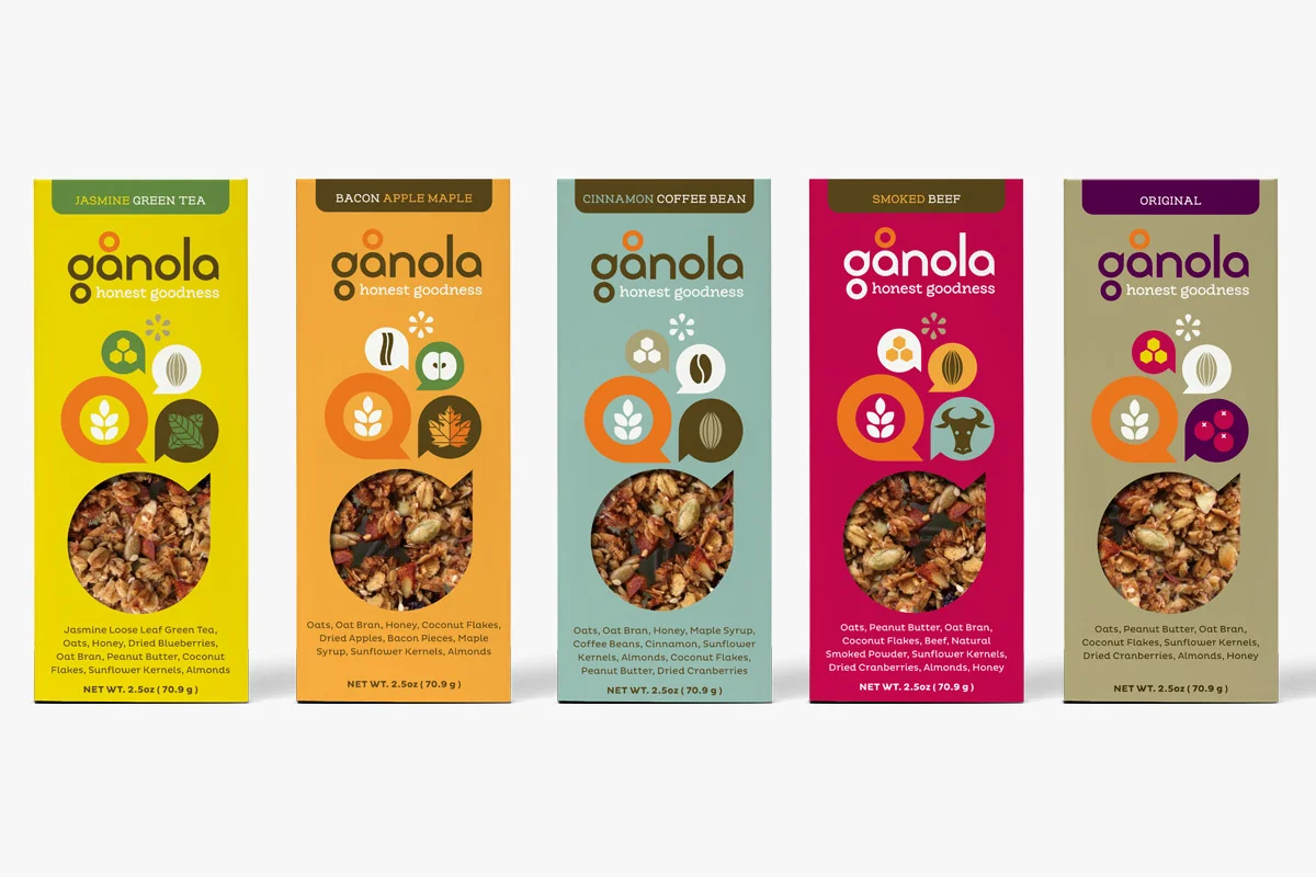 Five colorful snack packages of granola with different flavors, including jasmine green tea, bacon apple maple, cinnamon coffee bean, smoked beef, and original. Each package features a transparent window showing the granola inside, with various ingre