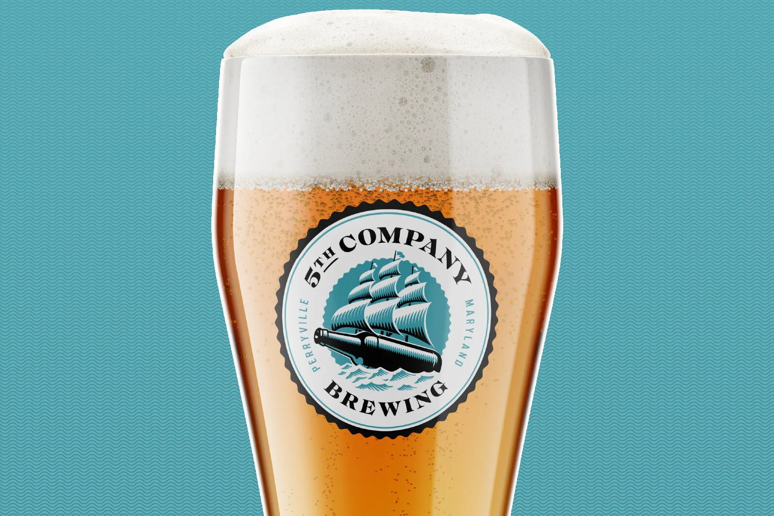 A glass of beer with a foamy head and a label of 5th Company Brewing from Perryville, Maryland.