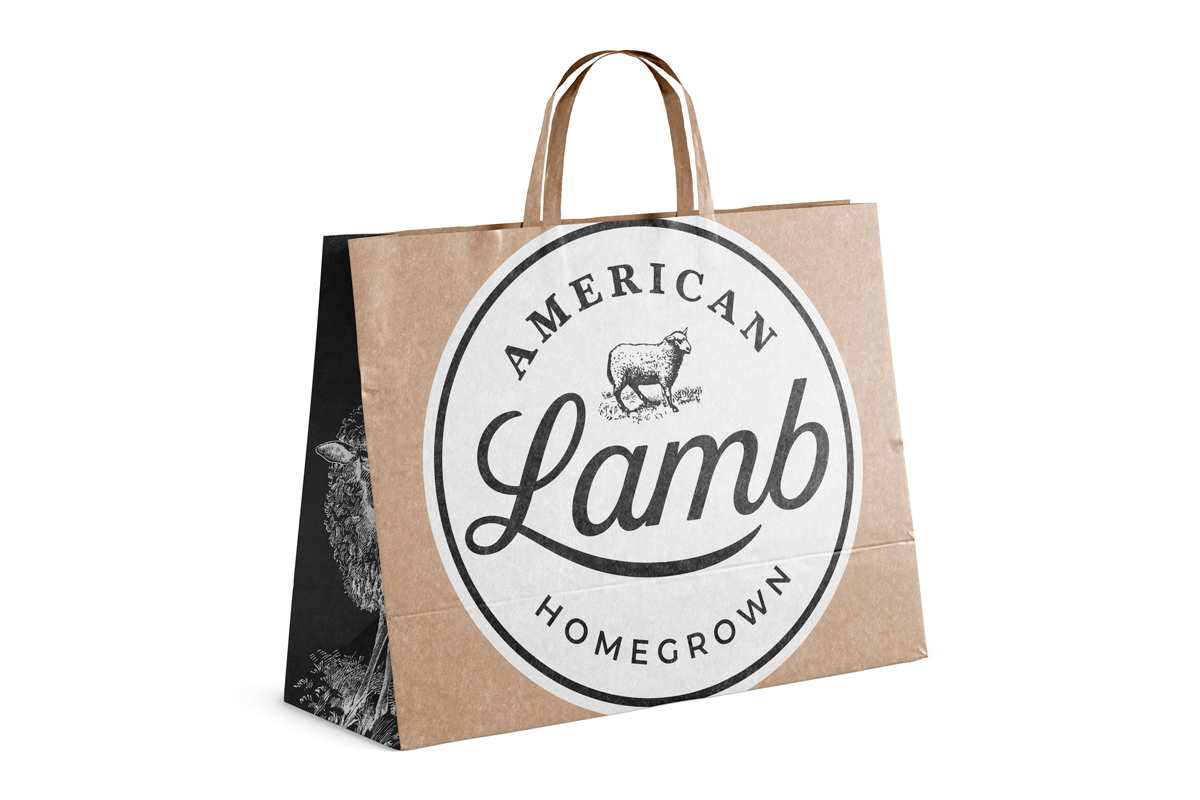 A paper shopping bag with a circular logo that reads "American Lamb, Homegrown," featuring a sheep illustration.