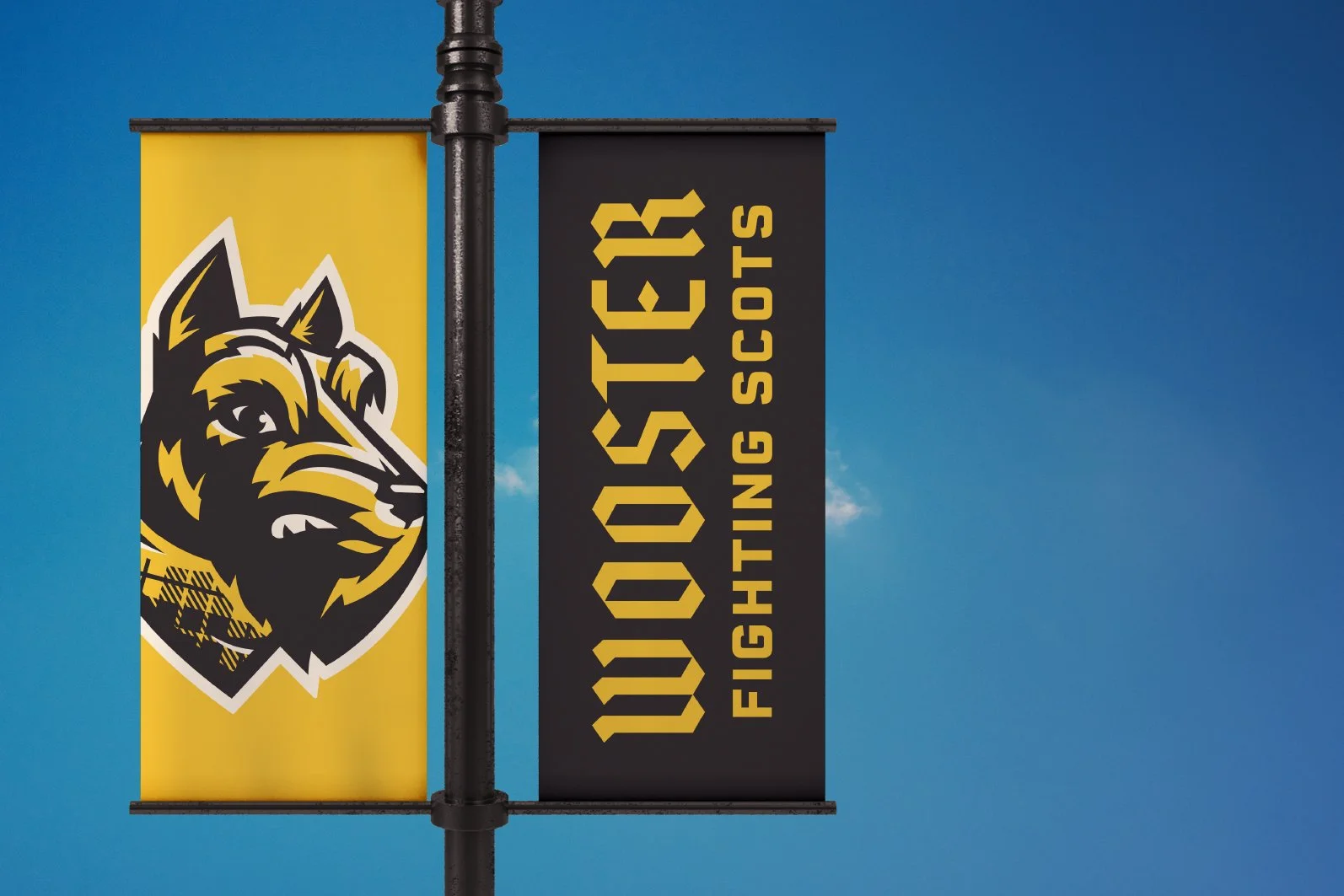 University of Missouri logo with a black and yellow dog mascot on a yellow background on the left, and the text 'Missouri Fighting Scots' in yellow on a black background on the right, mounted on a black pole against a blue sky.