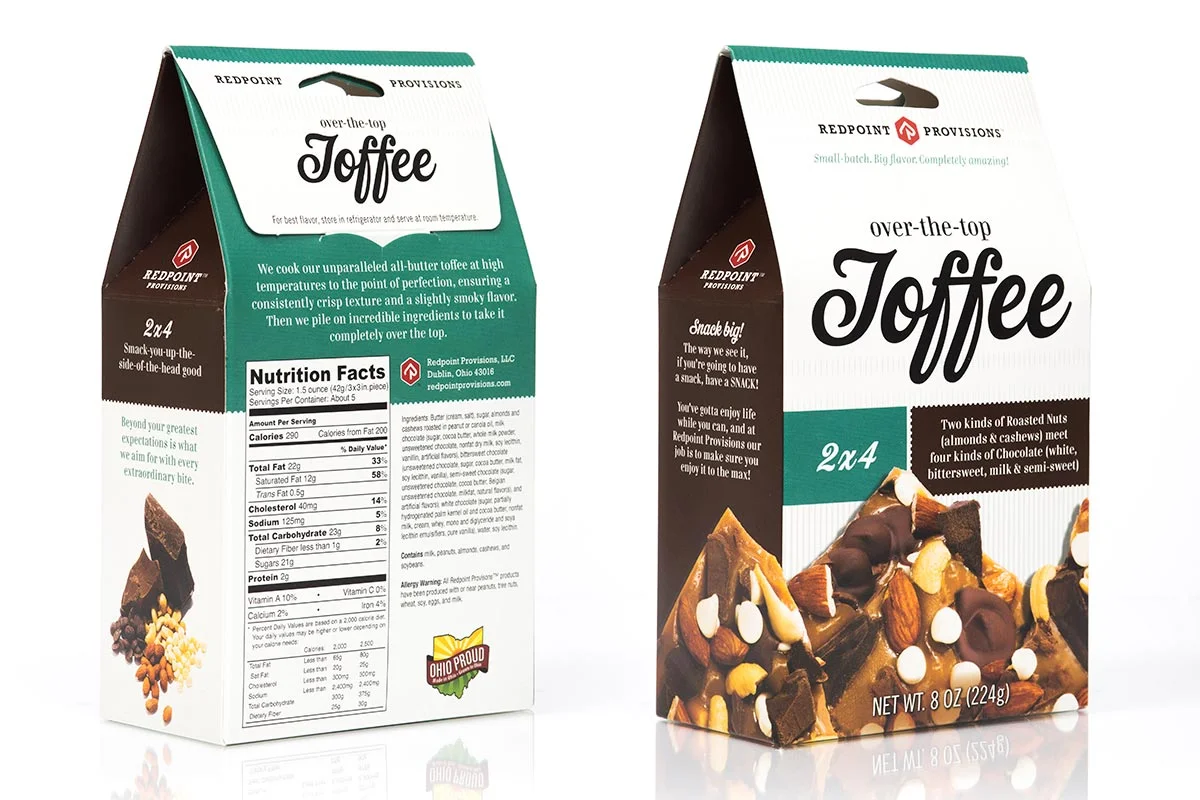 Box of Redpoint Provisions' over-the-top toffee with roasted nuts and chocolate, packaging features almonds, cashews, and different types of chocolate, 8 oz net weight.