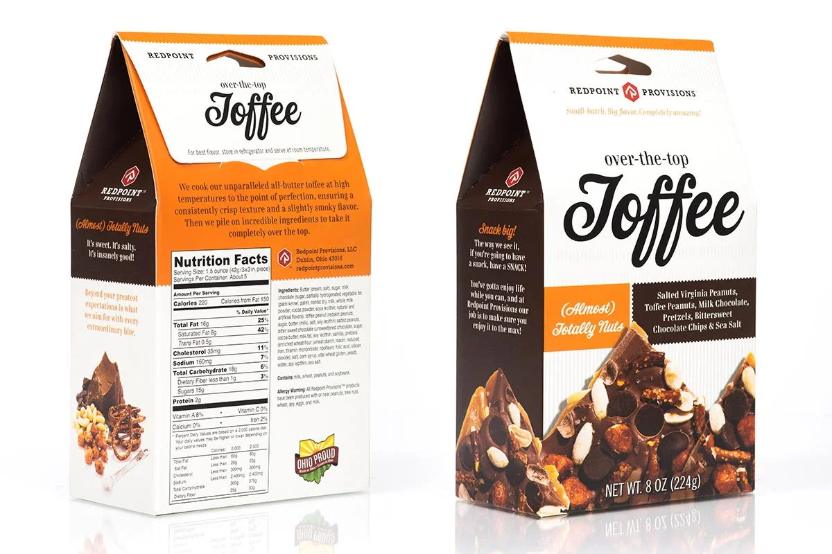 Two boxes of Redpoint Provisions over-the-top toffee, one showing the front with a picture of the toffee and the other showing the nutrition facts and ingredients.