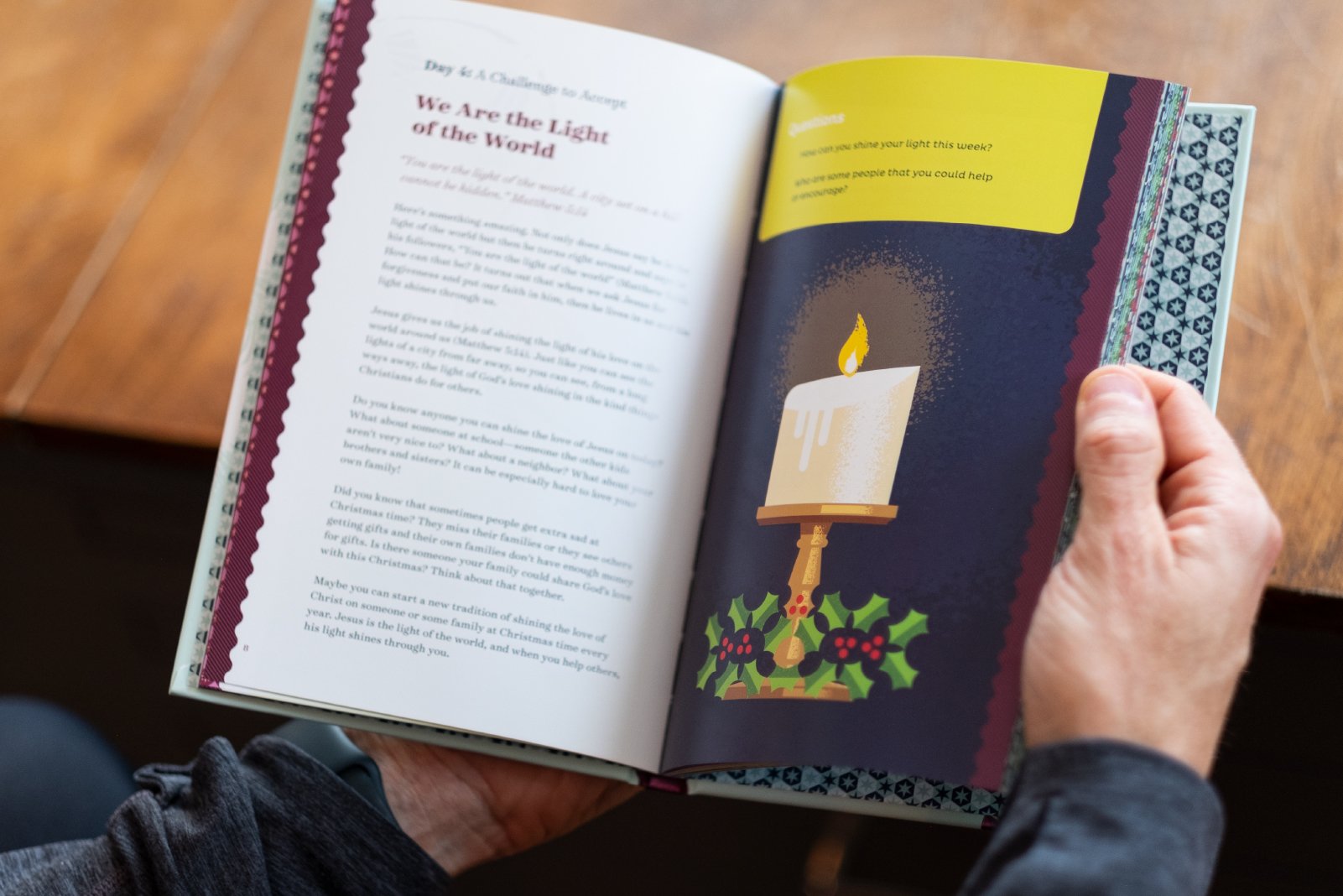 Open Christmas-themed book showing a candle illustration and text about light and Christmas traditions.