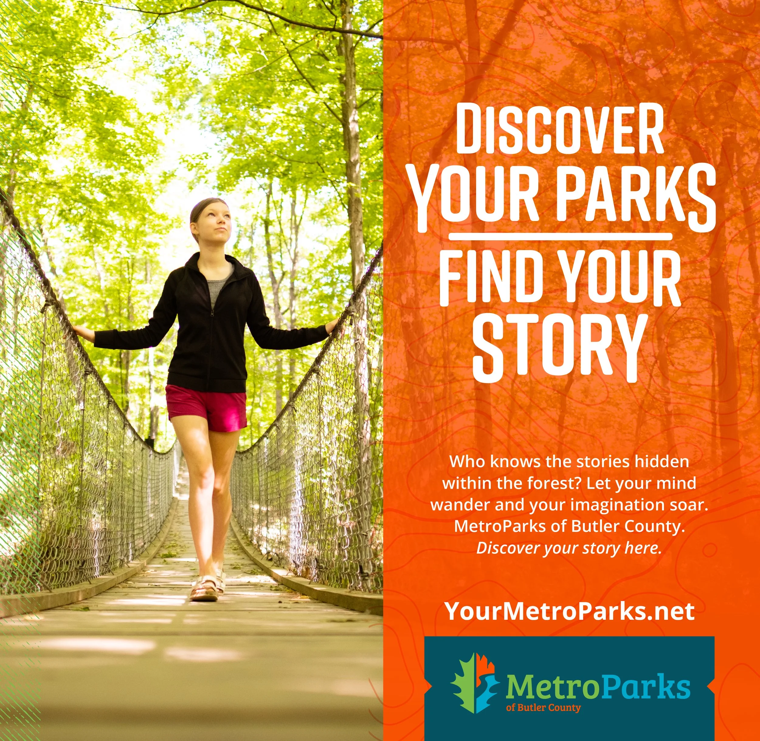 A woman walking on a wooden suspension bridge in a forest with lush green trees, wearing a black jacket and pink shorts, holding the bridge rails.