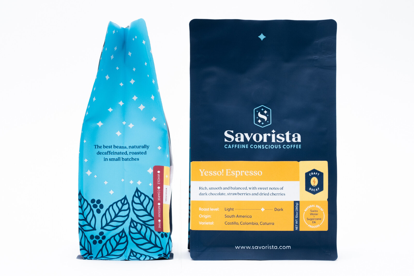 Two bags of coffee beans, one blue and one navy blue, with labels indicating they are caffeinated and decaffeinated, respectively. The blue bag features a leaf and berry design, and the navy bag has branding for Savorista with a description of Esress