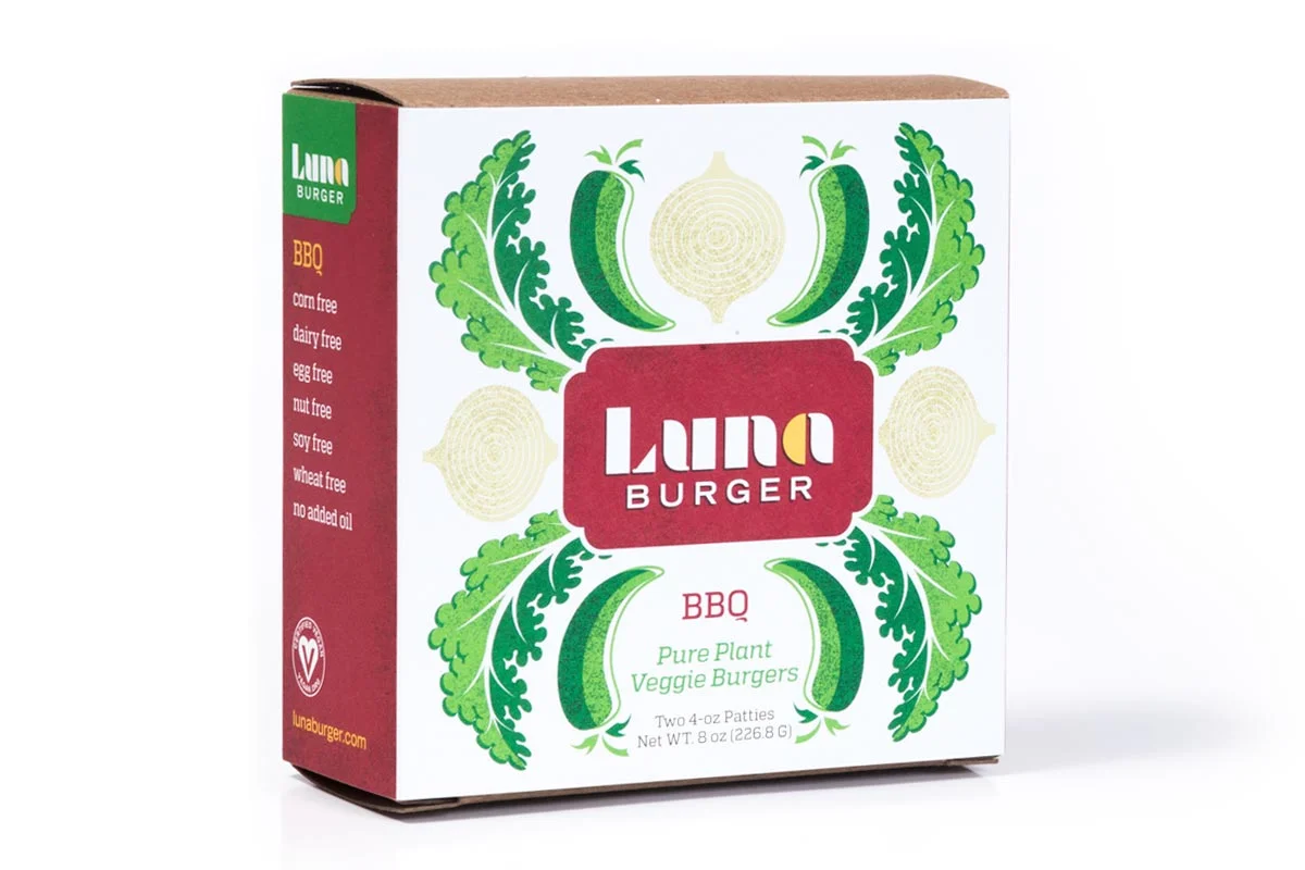 Front of a Luna Burger box with green and yellow illustrations of cucumbers, onions, and leafy greens, labeled as BBQ flavor, vegan, gluten-free, soy-free, and dairy-free.