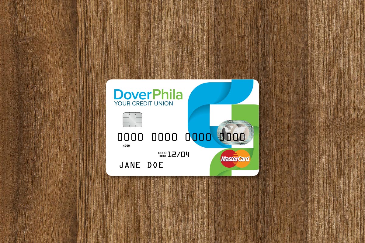 Dover Phila credit union MasterCard on a wooden surface labeled with the name Jane Doe and an expiry date of 12/04.