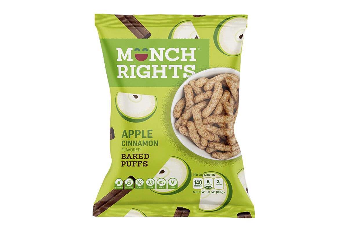 Green bag of munch rights apple cinnamon flavored baked puffs with images of apple slices and chocolate sticks.