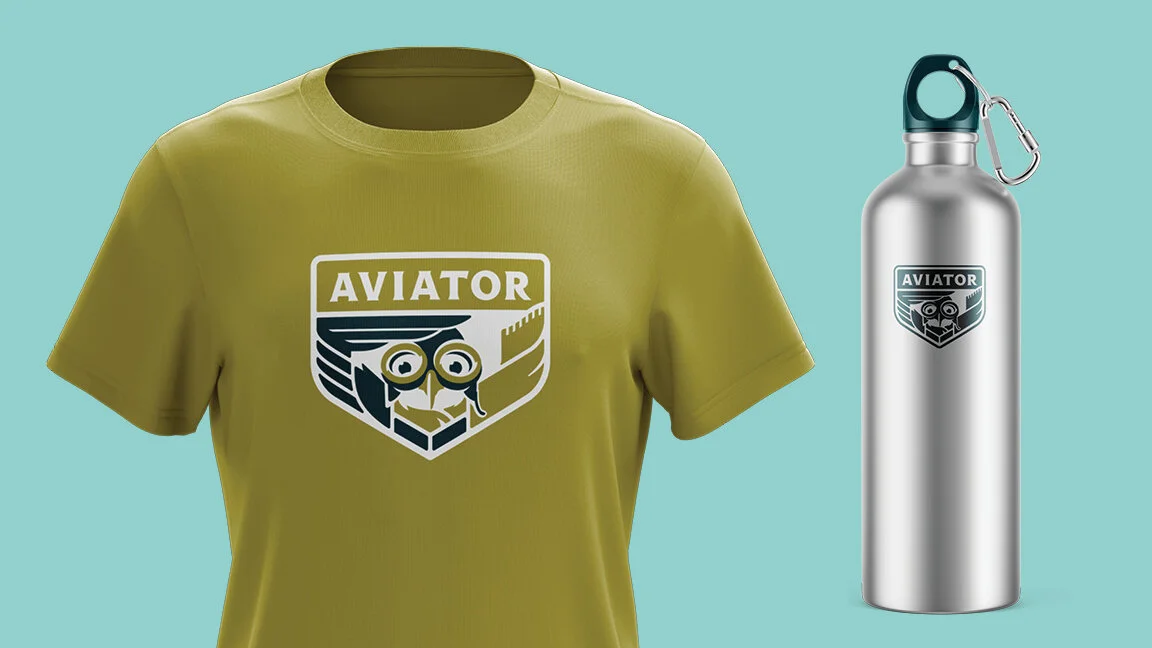 A lime green t-shirt and a silver water bottle, both with a logo that says 'AVIATOR' and features an owl with aviator goggles.