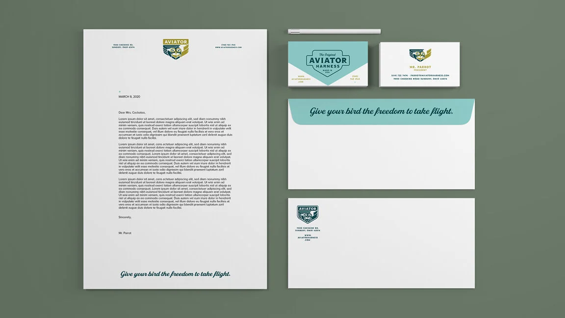 Set of branded stationery and accessories including letterhead, business card, envelope, and notepad, all with an aviation-themed logo and the slogan "Give your bird the freedom to take flight."