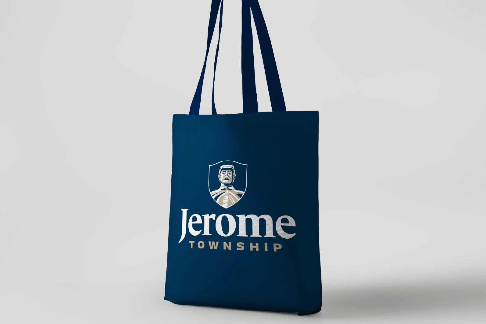 Blue tote bag with Jerome Township logo and name on a light gray background.