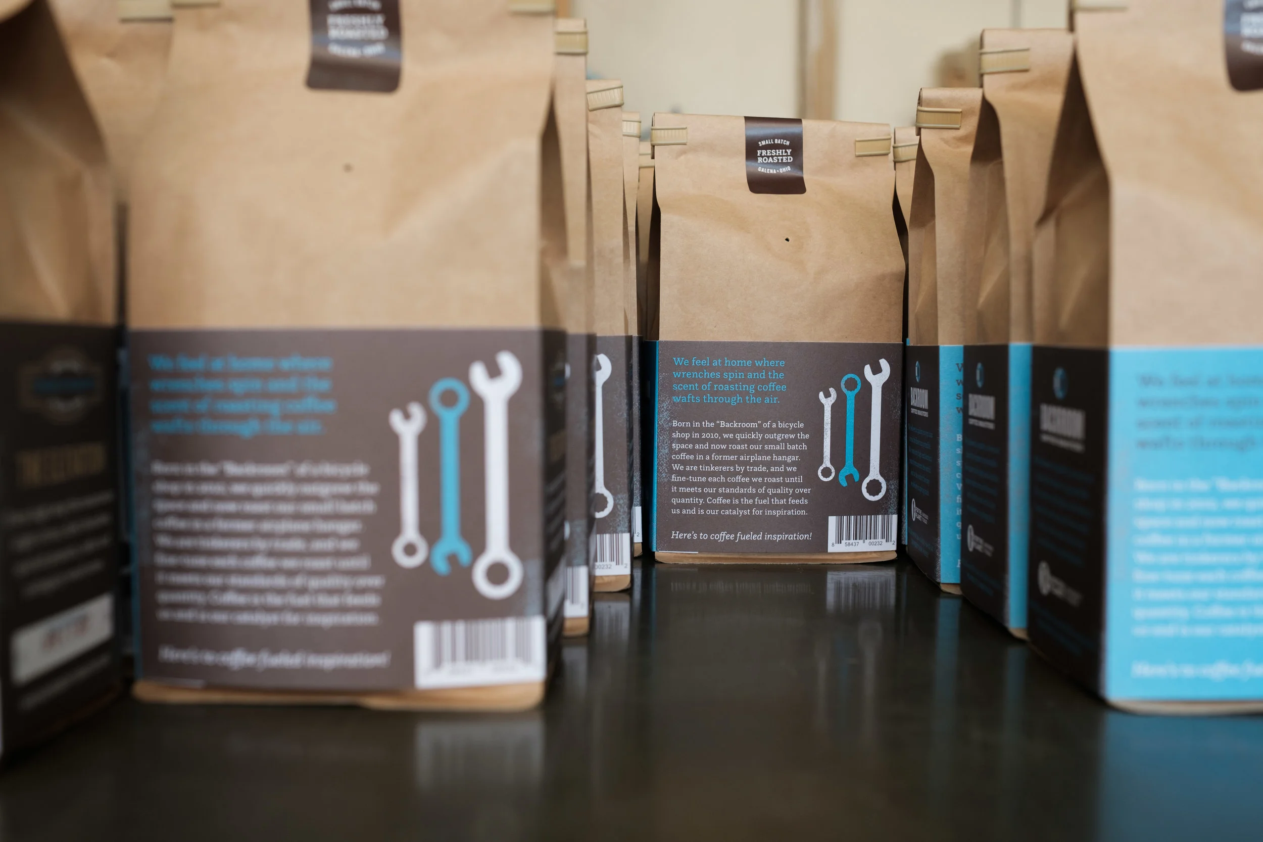 Boxes of roasted coffee beans on store shelves.