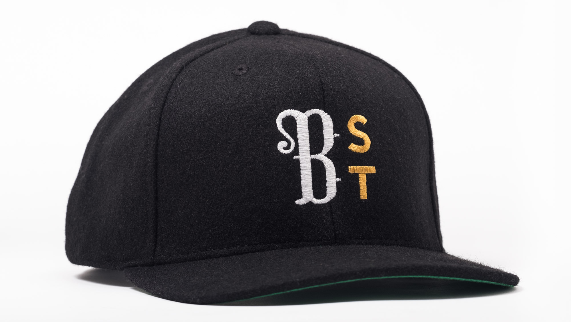 Black baseball cap with white, gold, and yellow embroidered letters: 'SR', 'S', and 'T'.
