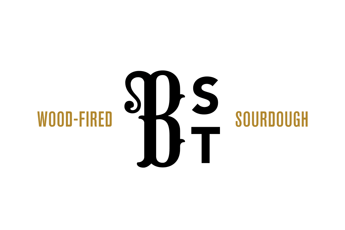 Logo with the words "Wood-Fired" on the left, "Sourdough" on the right, and stylized black letters "S," "D," "B," and "T" in the center.