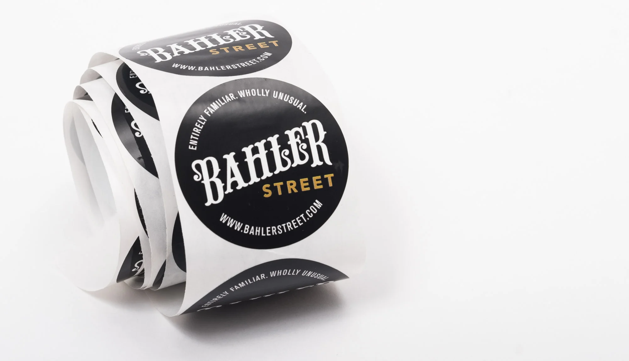 Roll of stickers with a black circle logo that says 'Bahler Street' and website www.bahlerstreet.com.