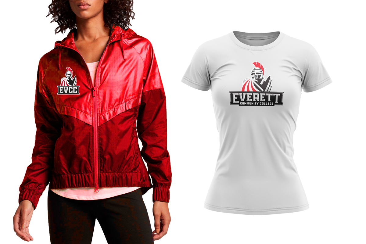 A woman wearing a red windbreaker jacket with a college logo on the chest, standing next to a white T-shirt with the same college logo printed on the front.