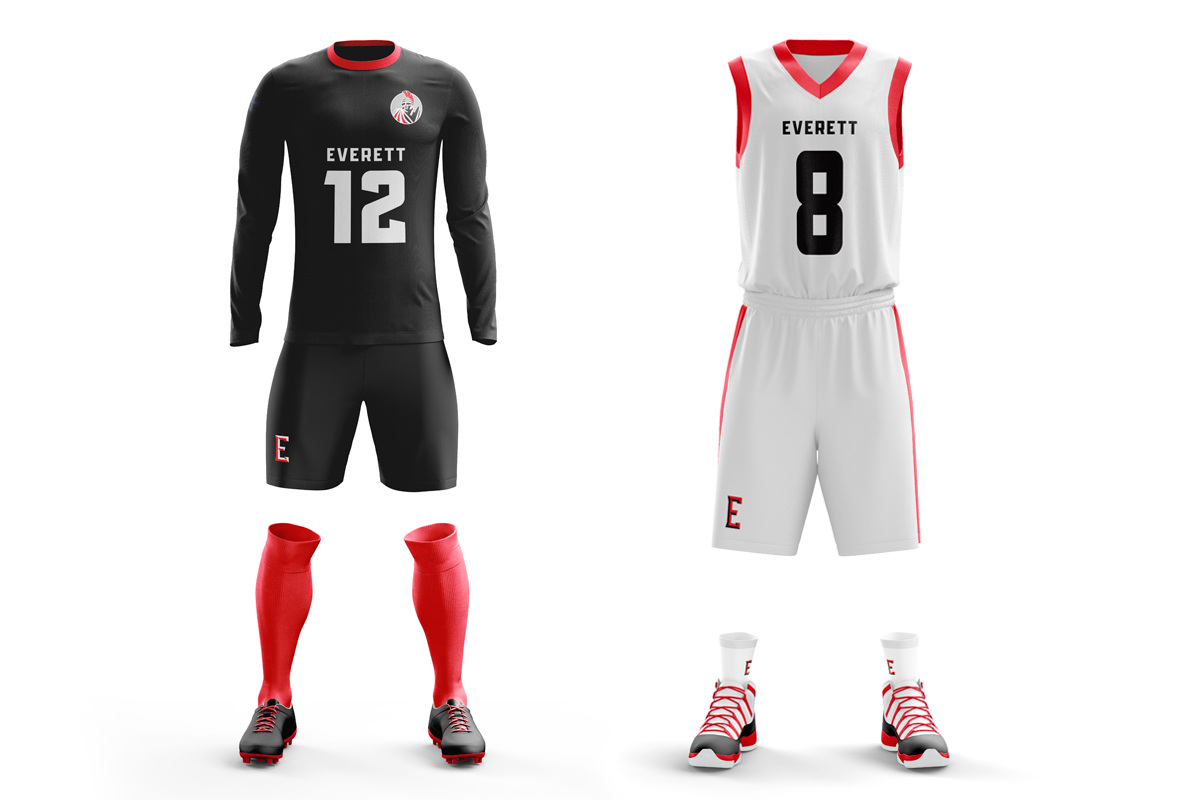 Two sets of athletic uniforms on display: the left with a black long-sleeve jersey with the number 12 in gray and the word Everest, paired with black shorts, red socks, and black cleats; the right with a white sleeveless jersey with the number 8 in b