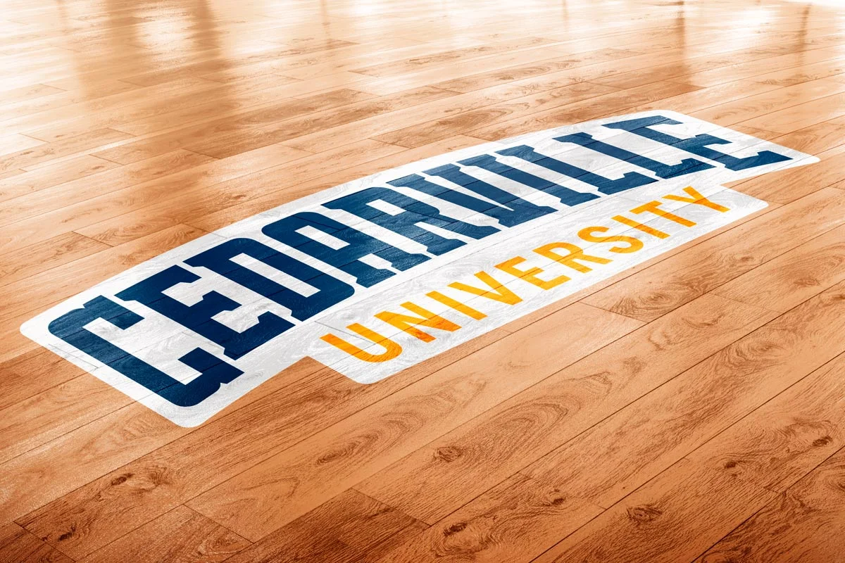 University of Louisville logo on a wooden floor.