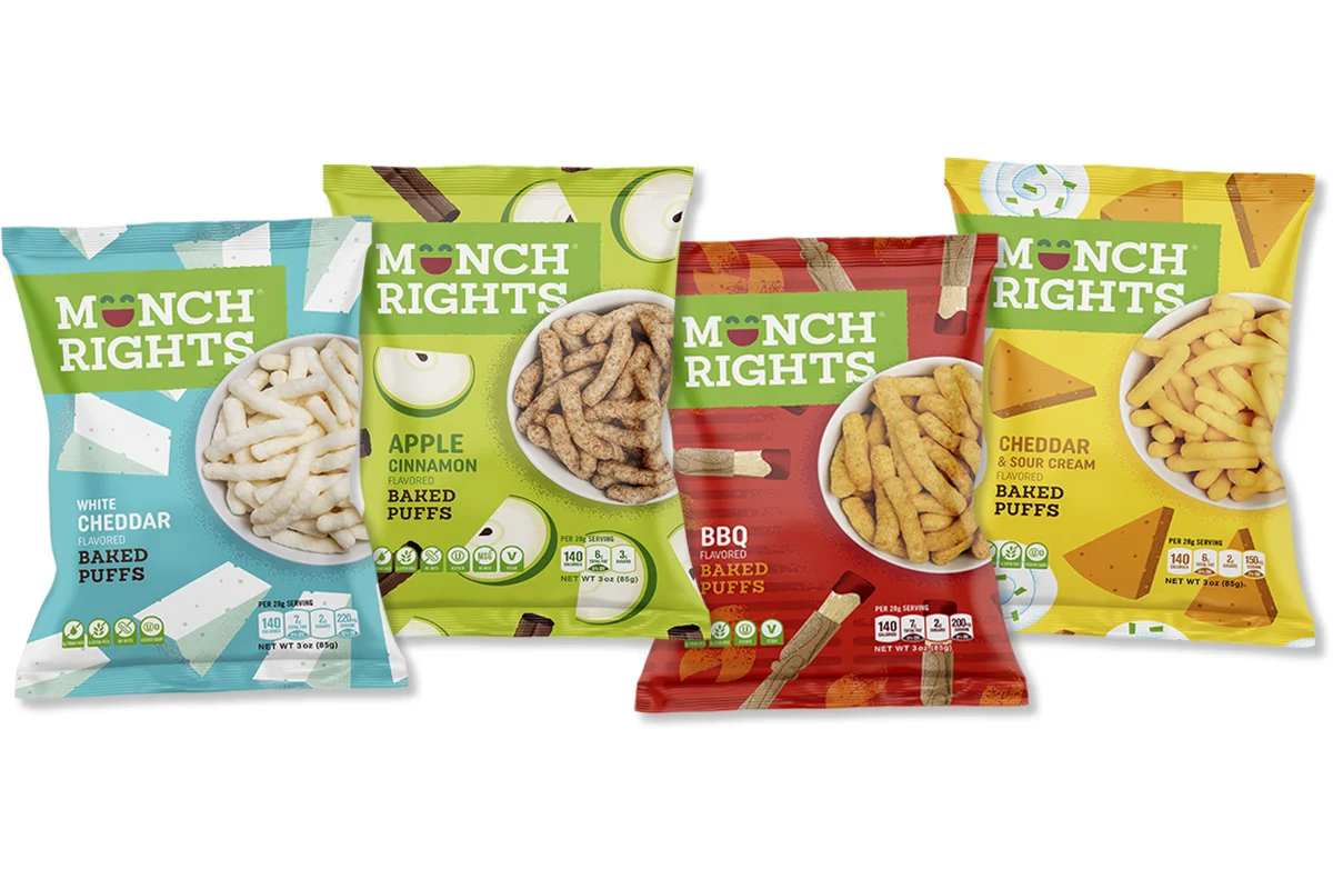 Four colorful snack bags of 'Monch Rights' baked puffs with different flavors: white cheddar, apple cinnamon, BBQ, and cheddar & sour cream, arranged in a row.