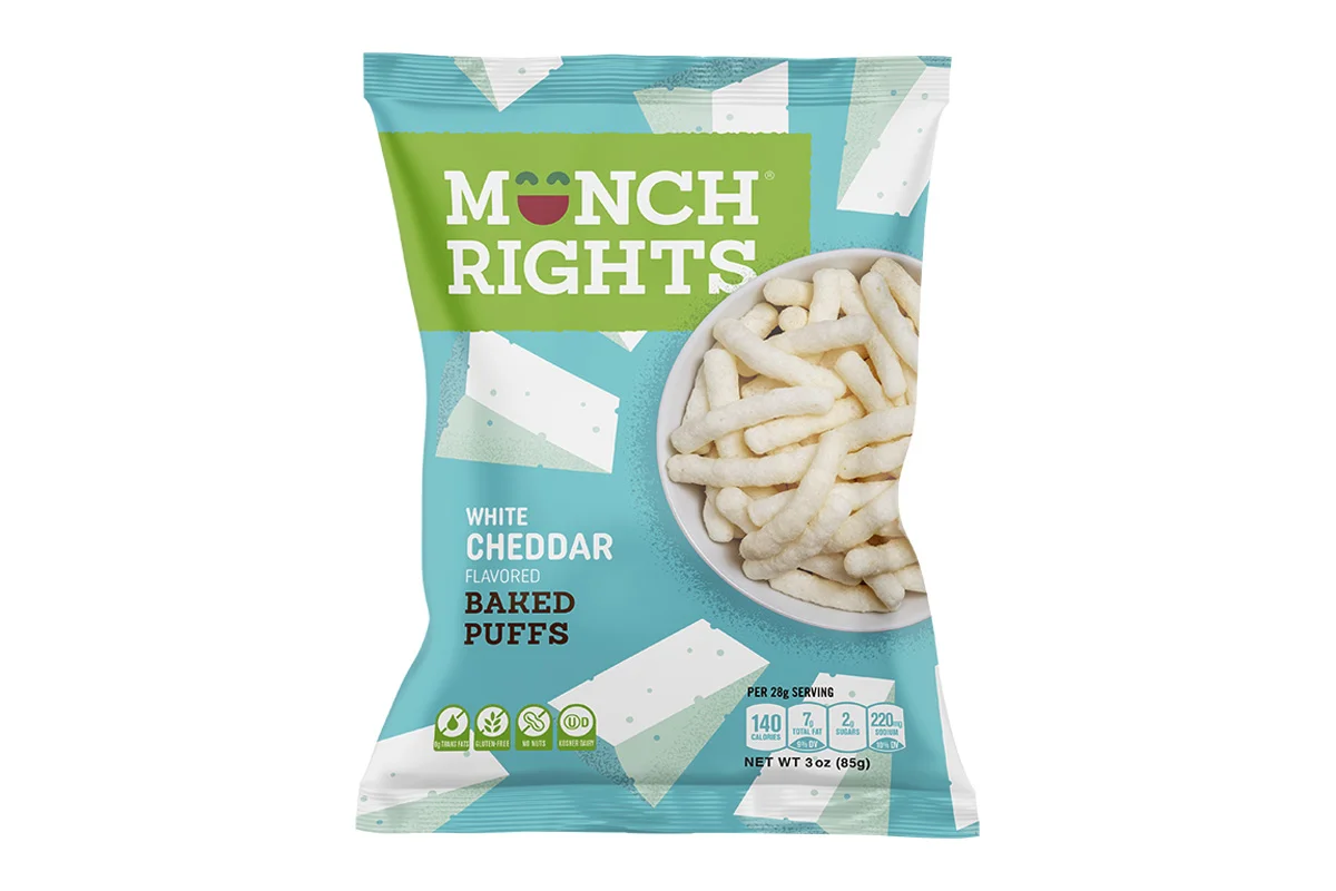 A bag of Moonch Rights White Cheddar Baked Puffs snack with a picture of the puffs in a bowl on the packaging.