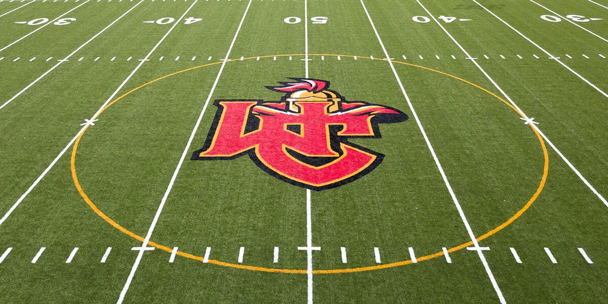 A football field with the Kansas City Chiefs logo at the center