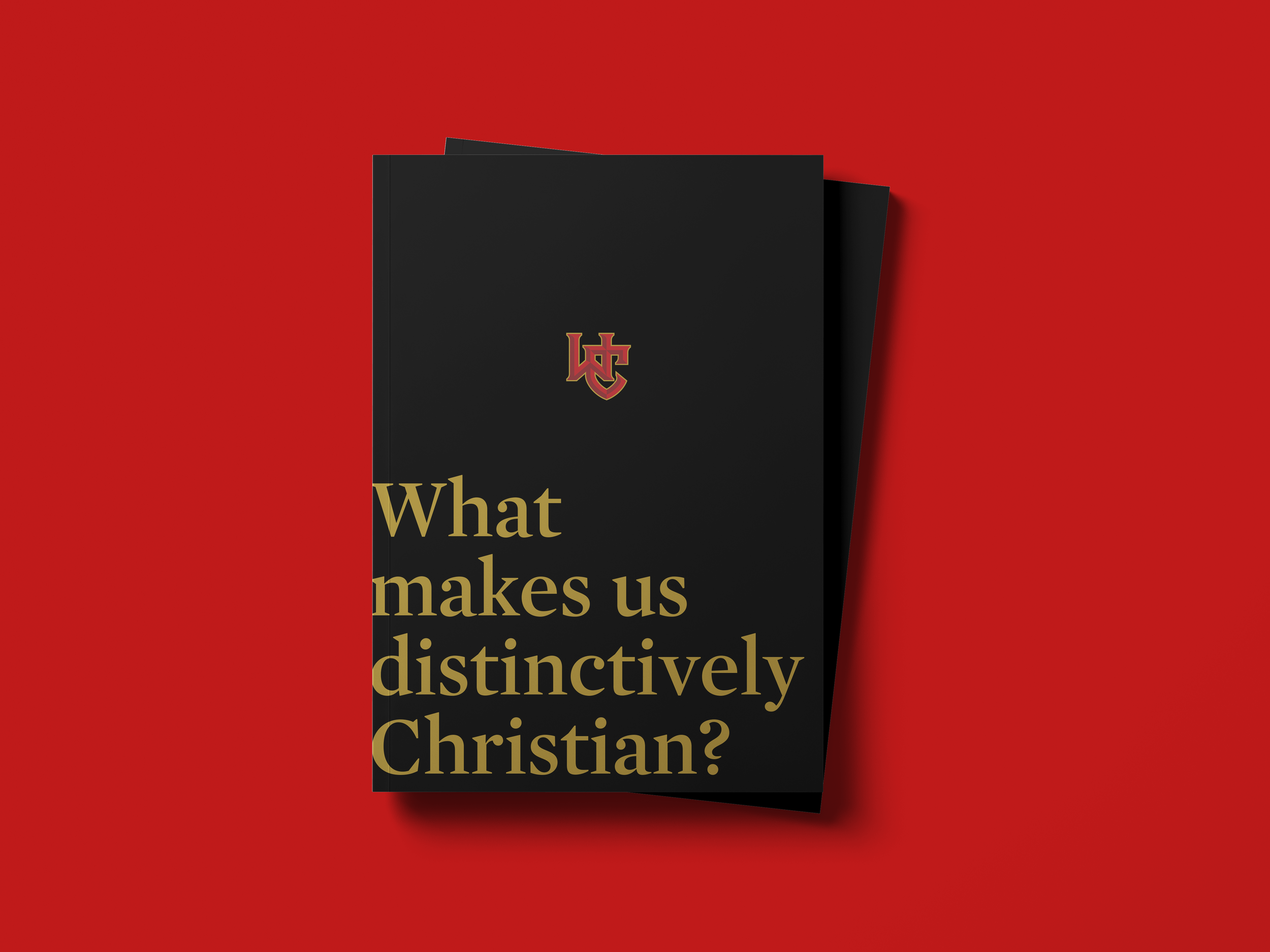 A black card with gold and red text asking, 'What makes us distinctively Christian?' placed on a red background.