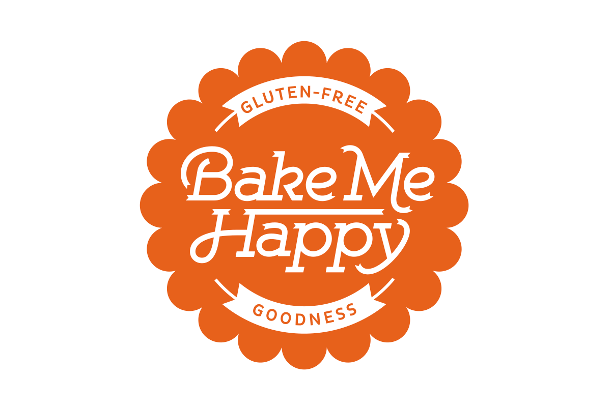 Orange badge with scalloped edges and the text "Bake Me Happy" centered. The top arc reads "Gluten-Free" and the bottom arc reads "Goodness."
