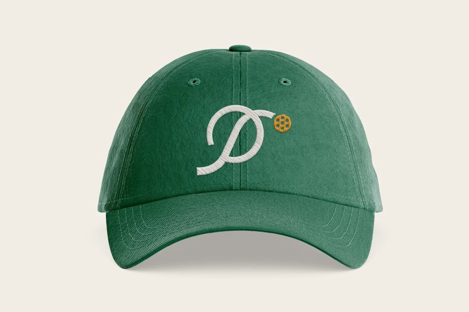 Green baseball cap with embroidered white intertwined letters 'D' and 'S' and a small yellow biscuit or cookie embroidered nearby.