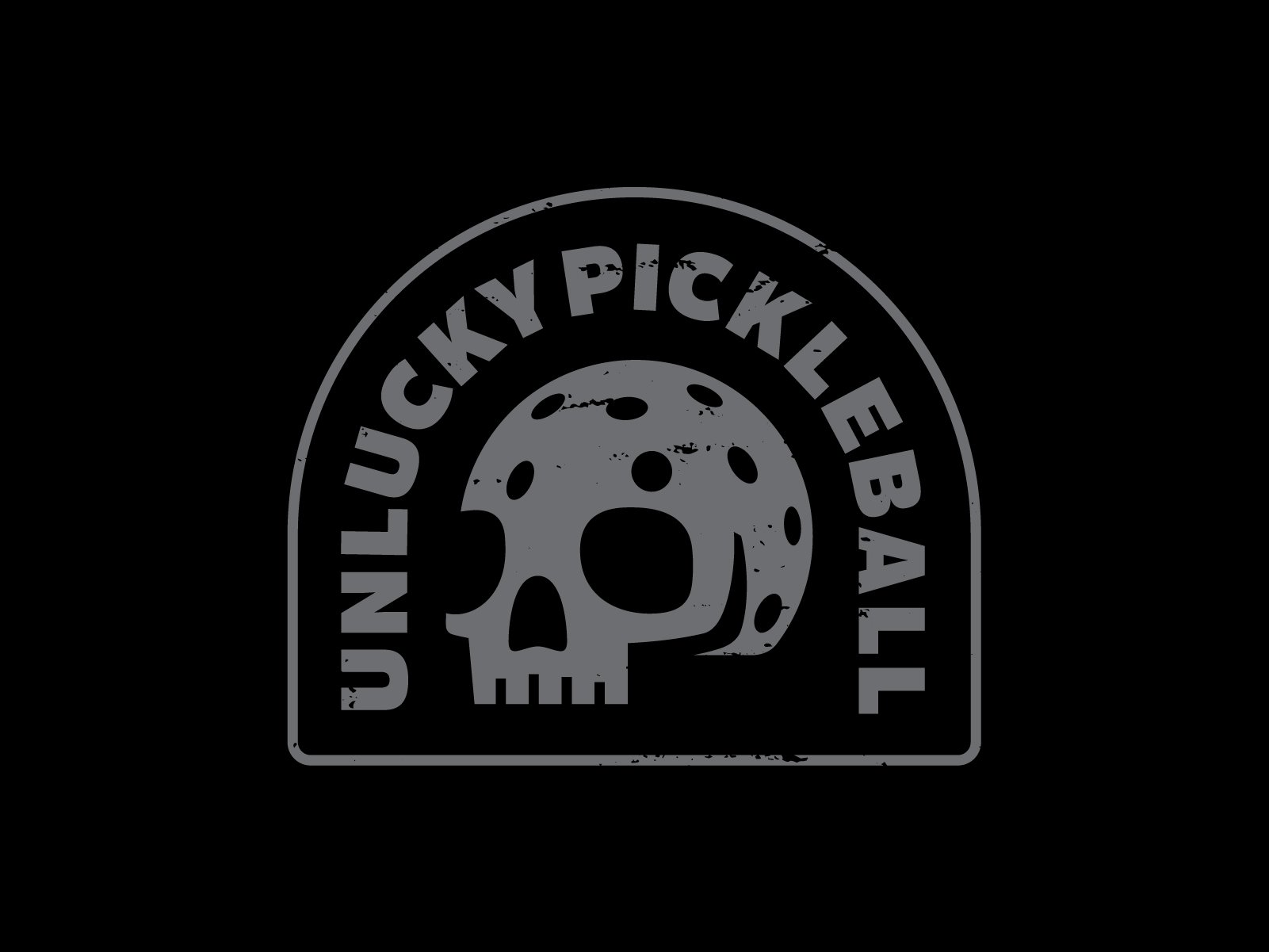 A dark-colored patch with a skull in the center and the words "Ultruckypickleball" curved around it.