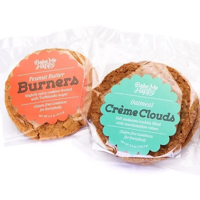 Two packaged cookies: Peanut Butter Burners and Oatmeal Creme Clouds on white background.