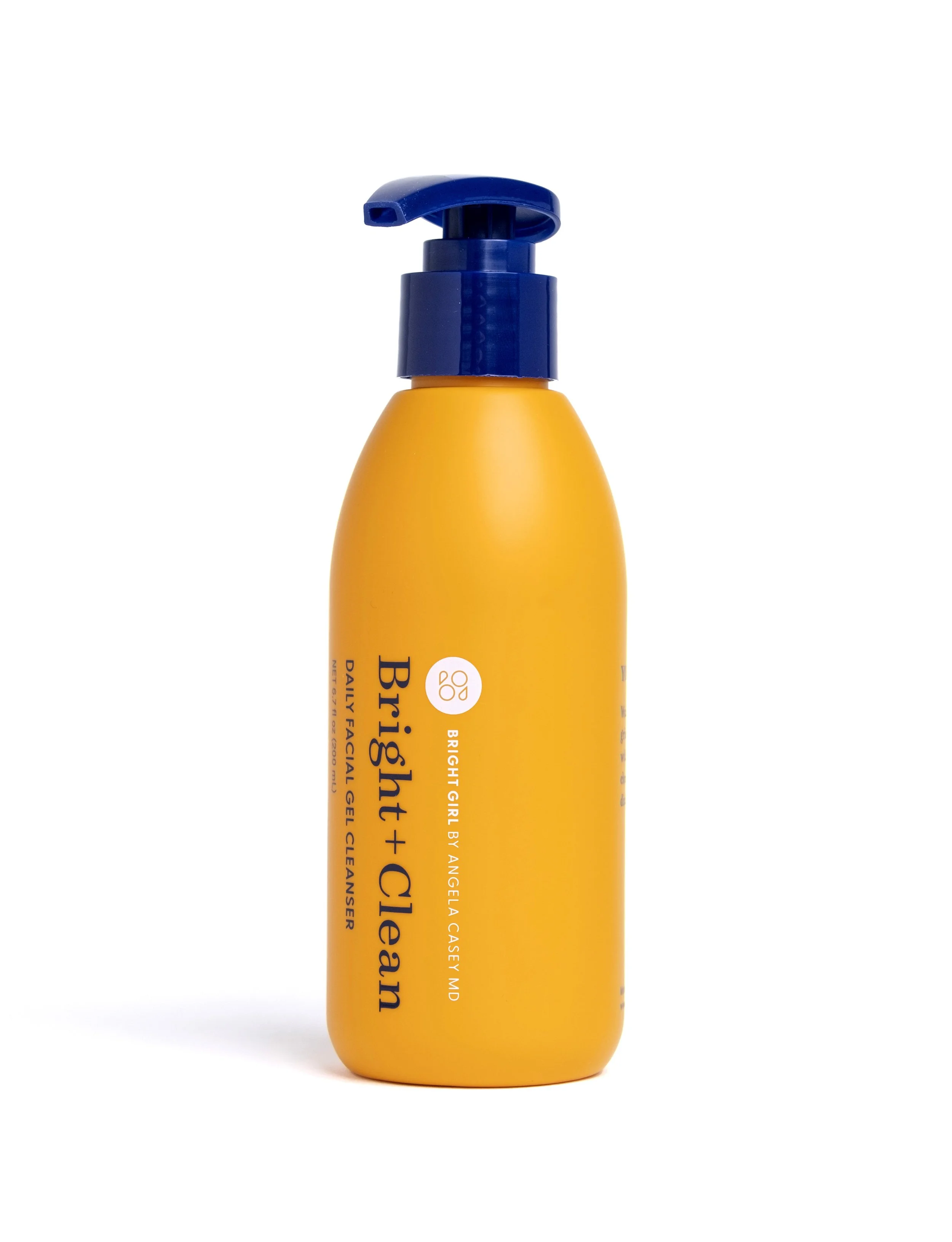 A yellow bottle of Bright Girl by Angela Casemayor MD facial cleanser with a blue pump dispenser against a white background.