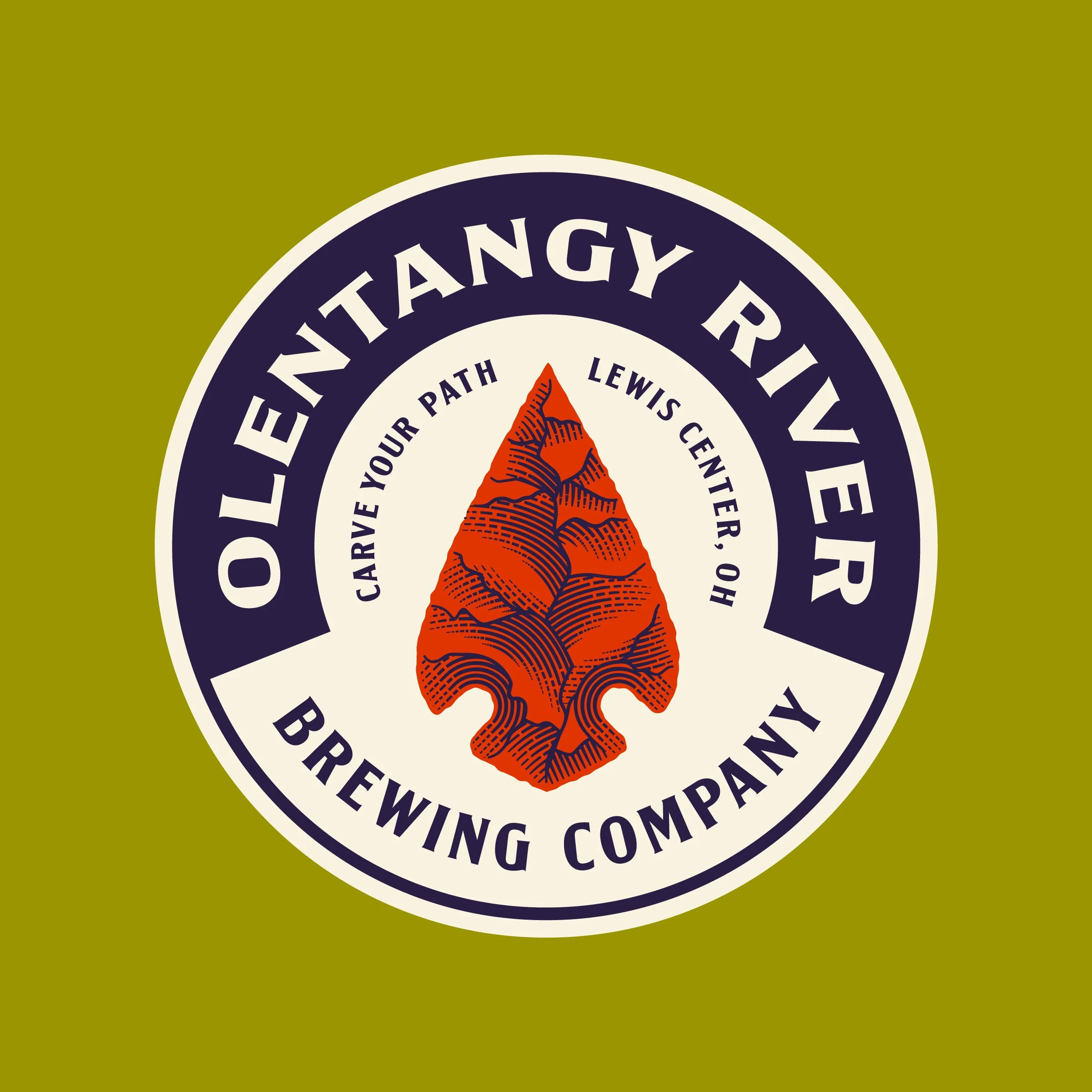 Close-up of a circular logo with a mountain image in the center, surrounded by the text 'LION TANGY TRAVELER' and other phrases, on a green background.