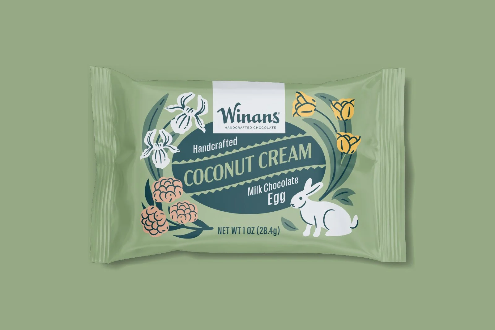 Package of Winans crafted coconut cream milk chocolate egg with illustrations of flowers, berries, a rabbit. Packaging design and illustration by Slagle Design. 