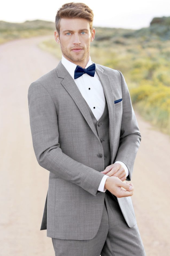 Man standing outside wearing a grey suit