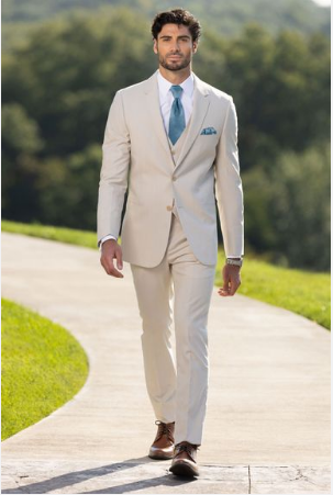 Man standing outside wearing a tan suit