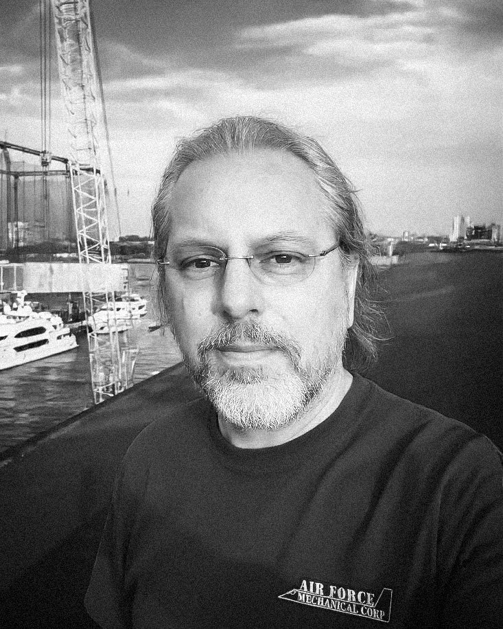 Vitek, partner at Air Force Mechanical Corp., in a glasses with a beard