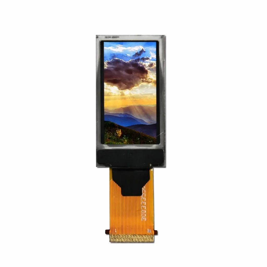 A digital display screen showing a landscape with mountains and a colorful sunset or sunrise.