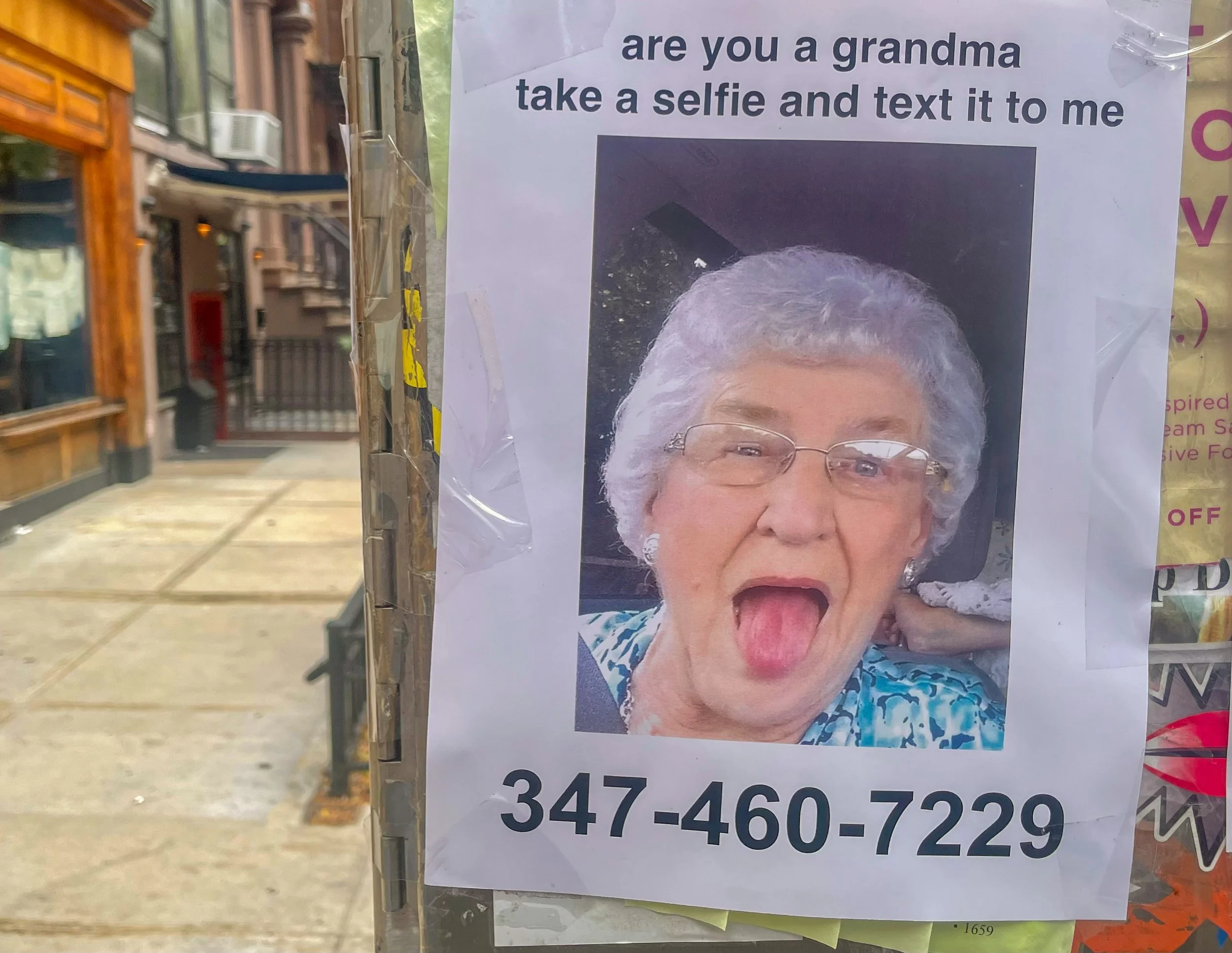 A flyer with a photo of an elderly woman making a funny face, sticking her tongue out. The flyer asks, 'are you a grandma take a selfie and text it to me' and displays a phone number, 347-460-7229.