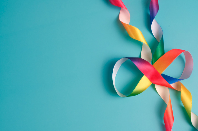 Colorful twisted paper streamers on a blue background.