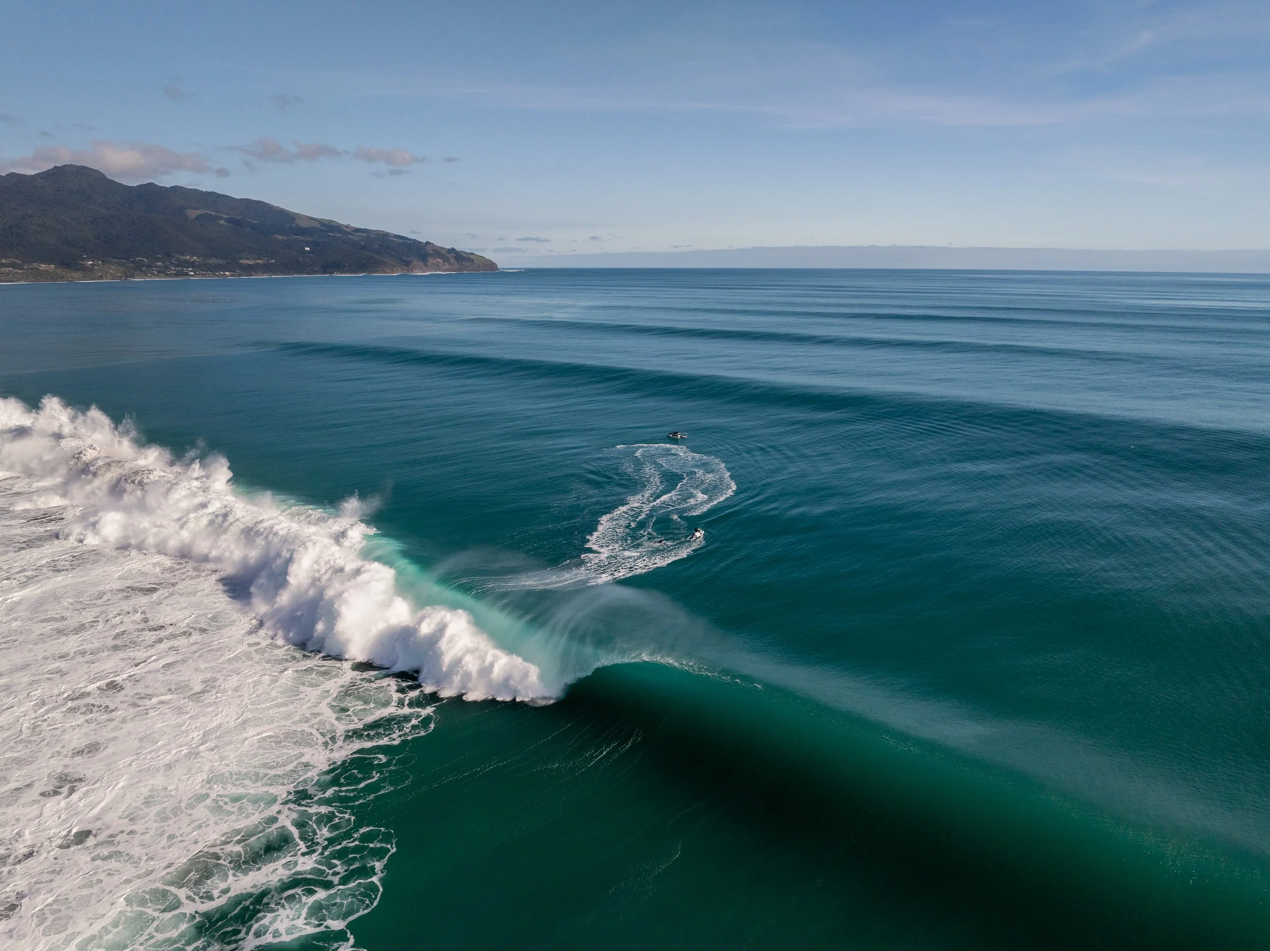 A moment of liquid perfection captured from above. This unridden peak breaks in crystalline blue water—a rare, glassy transformation of the Tasman Sea. Under flawless offshore winds, the ocean becomes a mirror, reflecting a stillness seldom seen on t