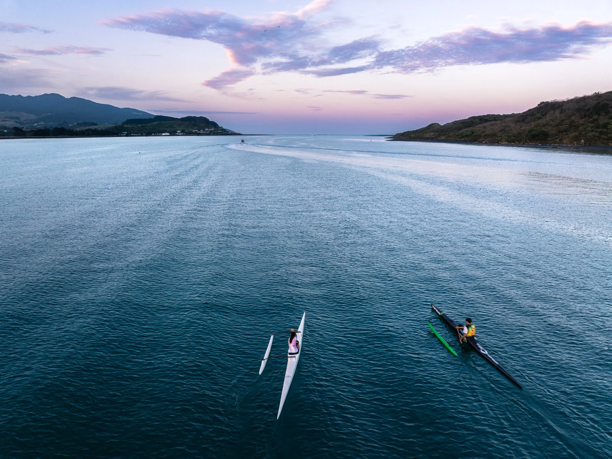 Captured at dawn in Raglan Harbor, this print documents the dedication of a brother and sister training to represent Aotearoa in international competition. A tribute to whānau, discipline, and the grit of the West Coast.