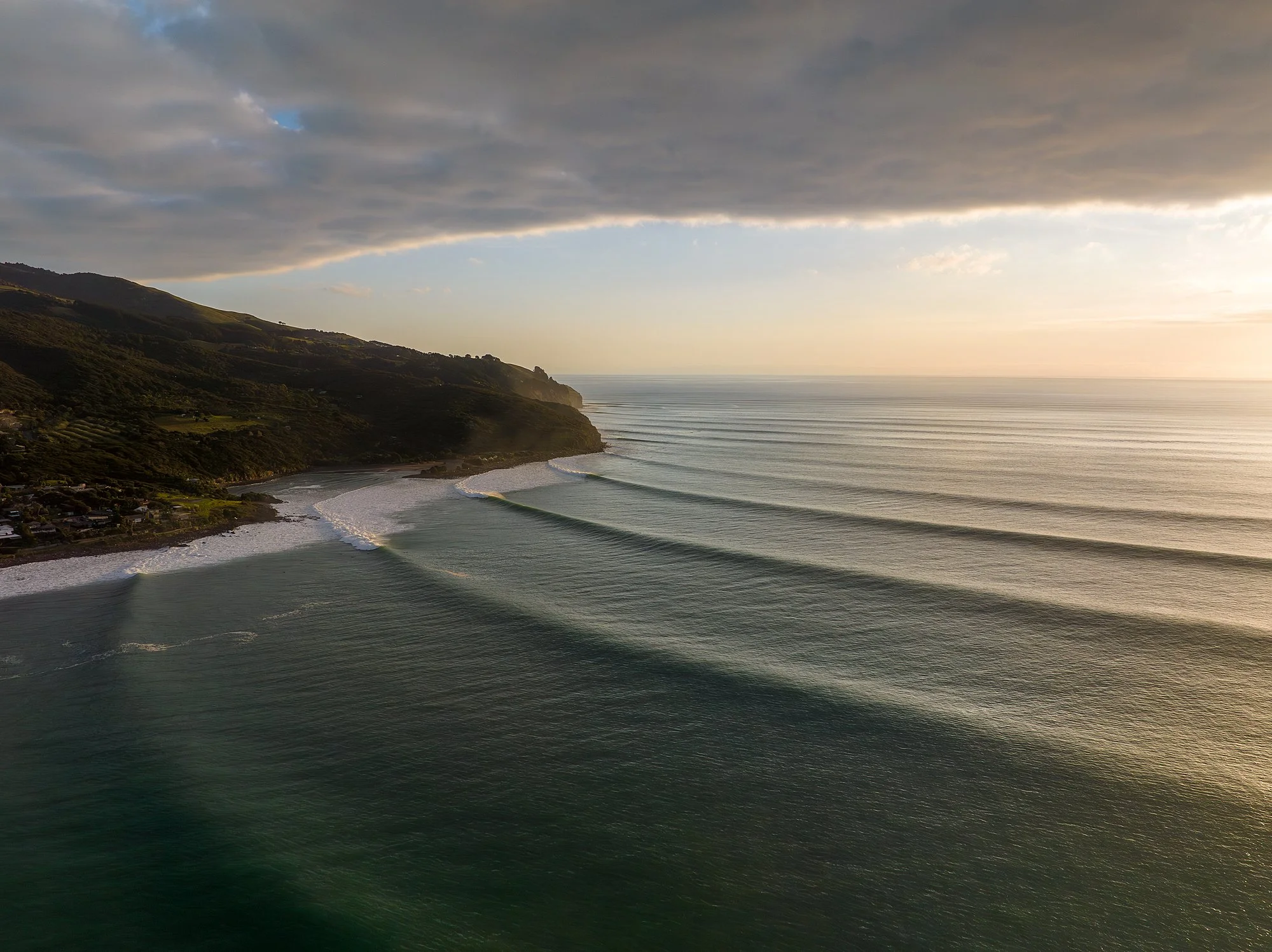 West Coast Wrap | Raglan, NZ

The setting sun catches the feathered spray of perfect lines as they wrap around the rugged headland. A golden sequence marching past Indicators and through to Whale Bay. This image captures the unique geography of Ragla