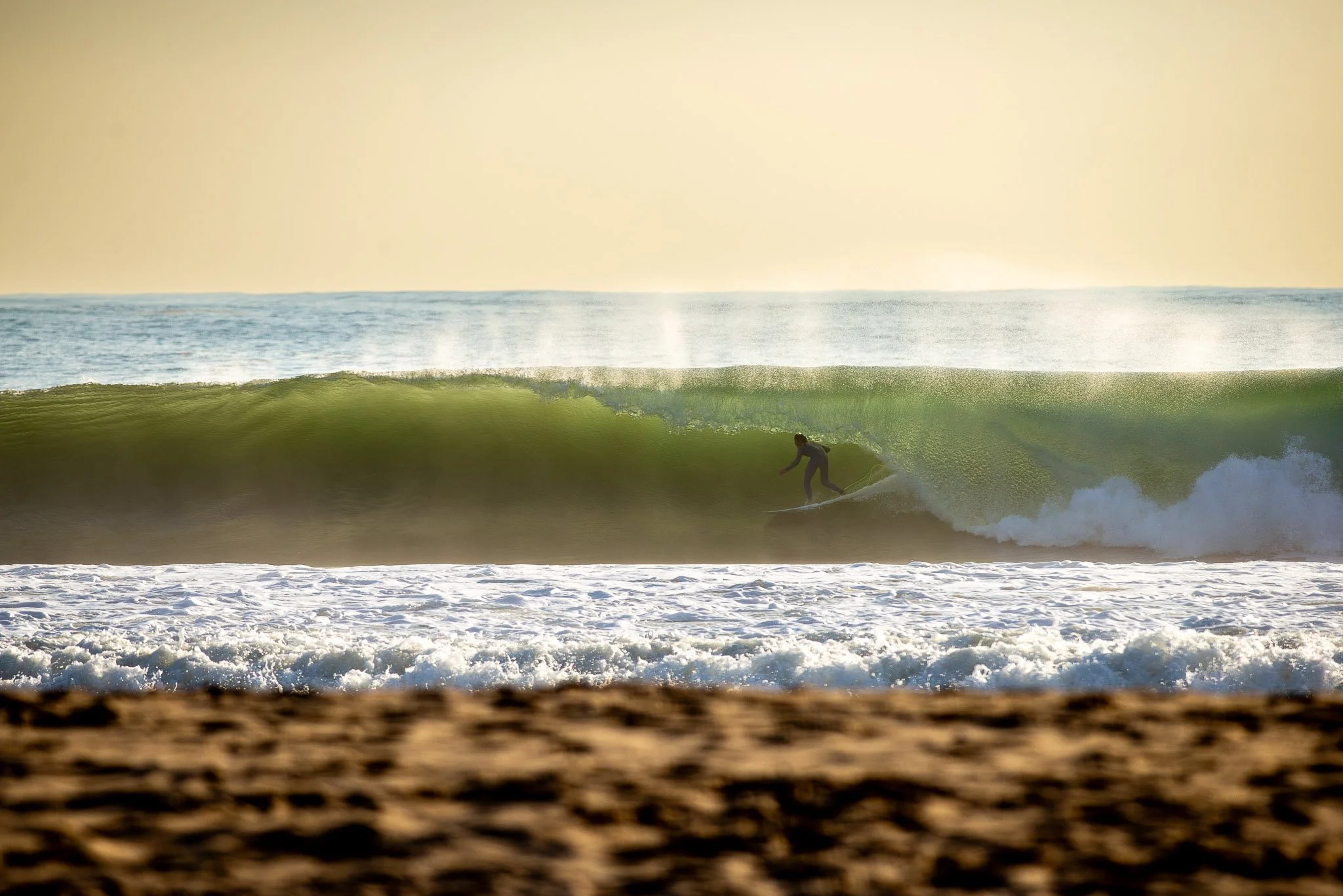 Editorial action shot of professional surfer Kanoa Igarashi riding a wave at Carcavelos, Portugal. Photographed by Paul Abbitt