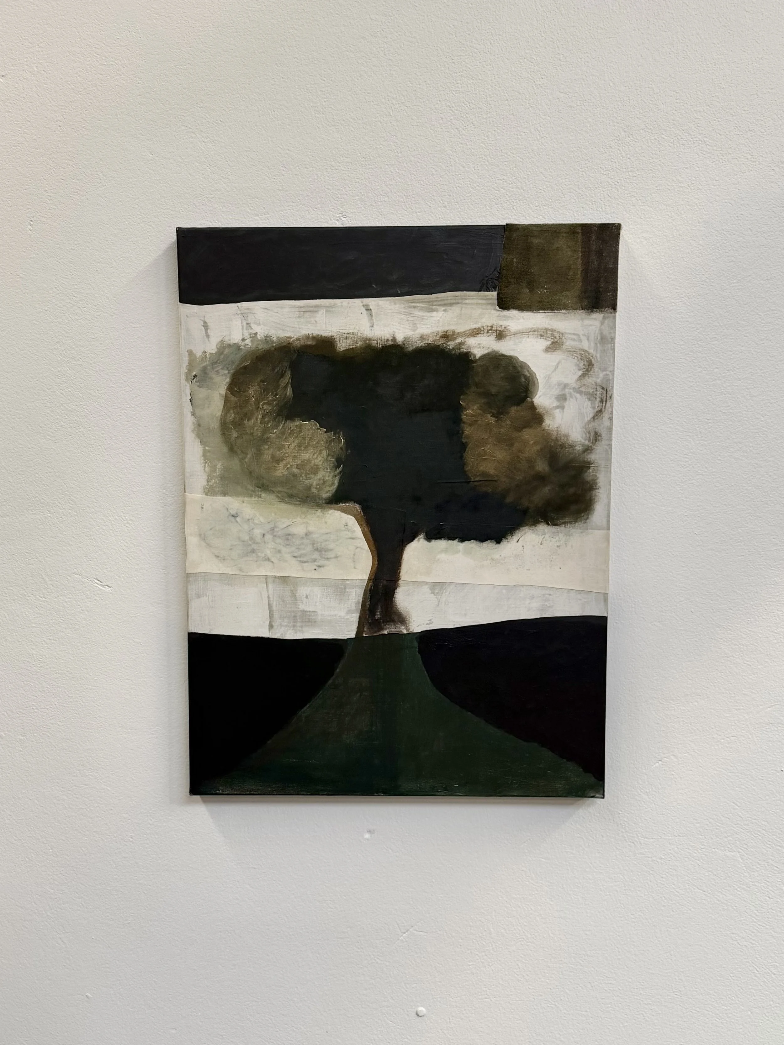 Abstract painting of a tree with a dark trunk and a large, rounded canopy, set against a muted background with dark and light areas, hung on a white wall.
