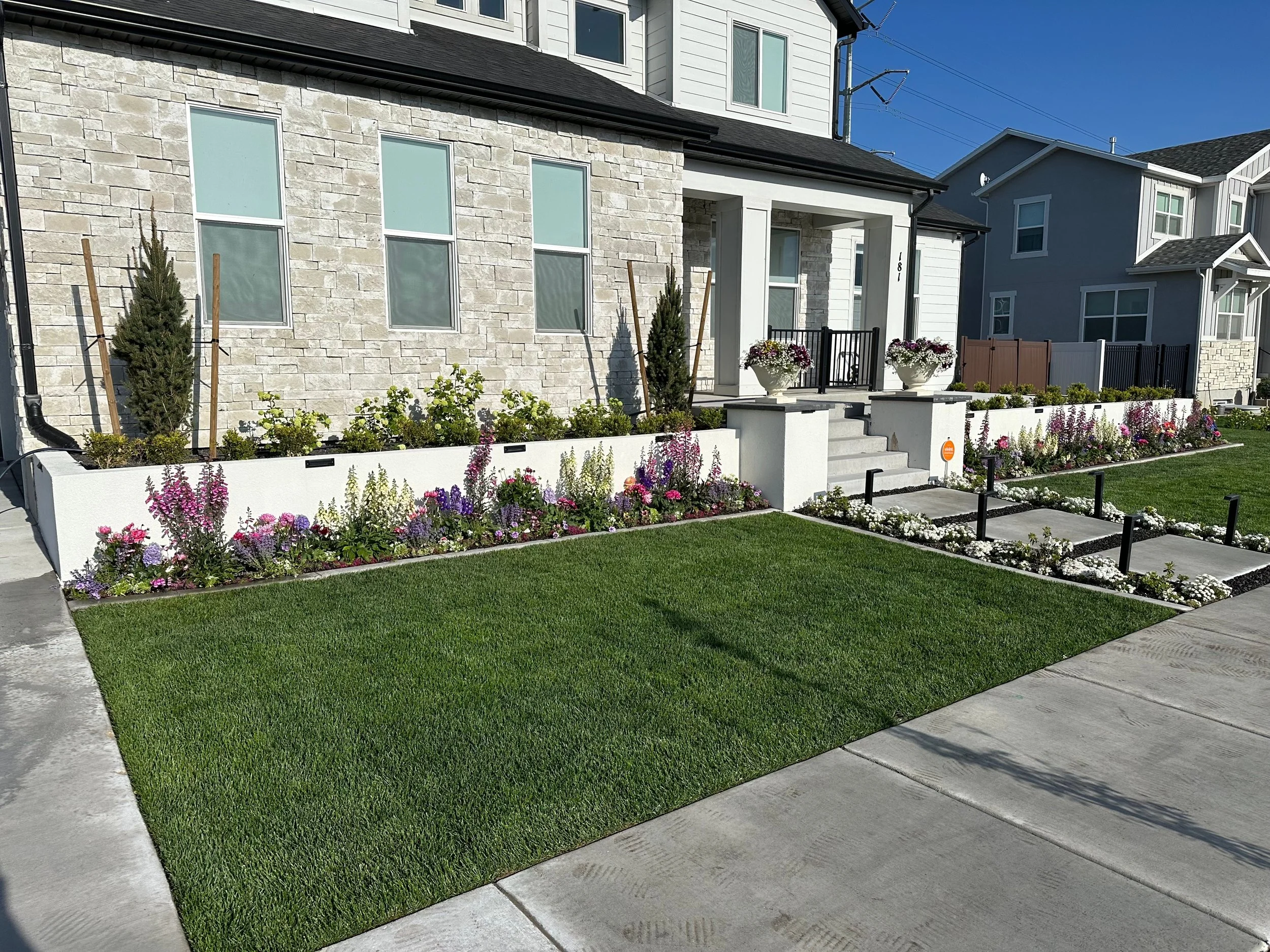 front yard with raised cinder block planters