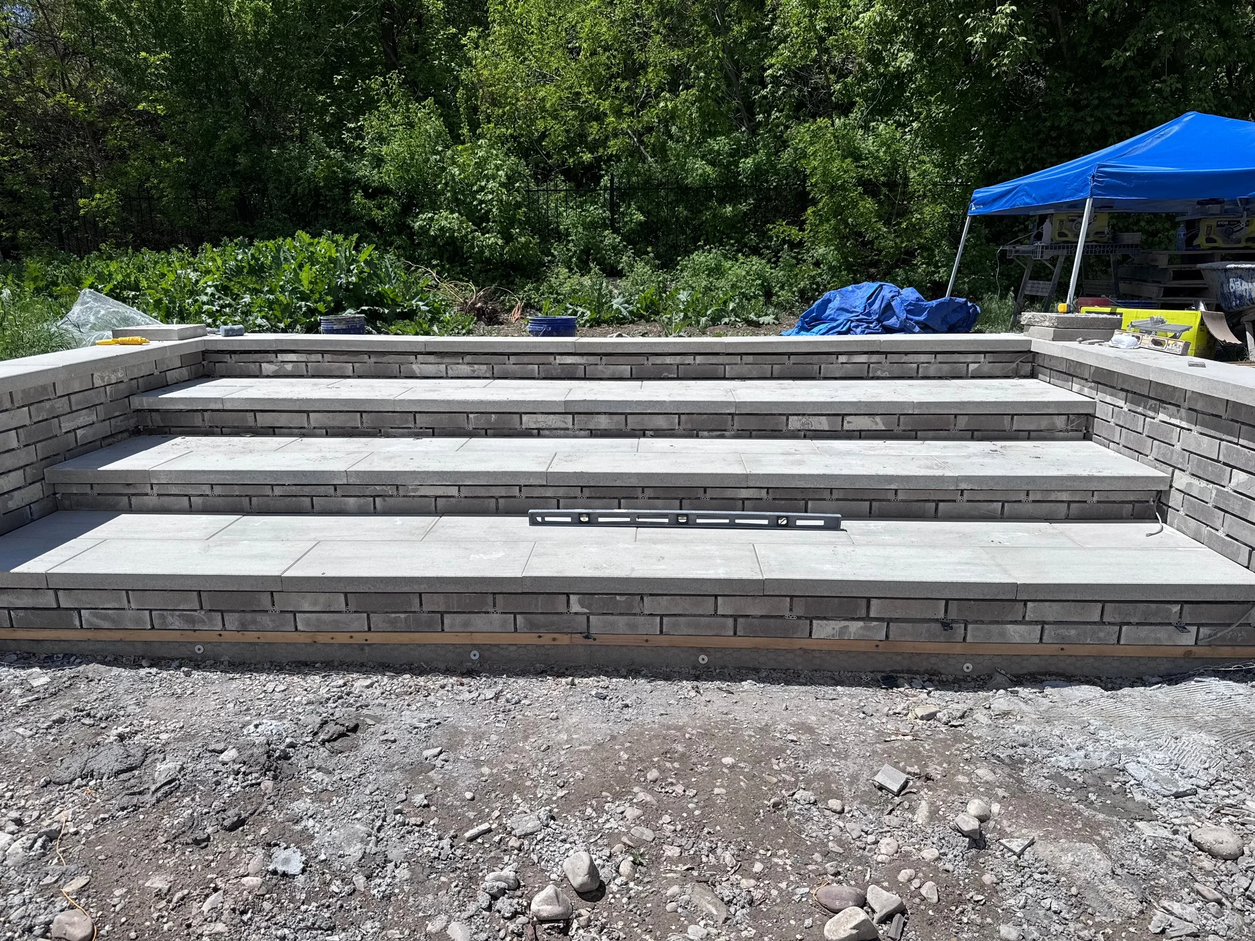 cinder block stairs with brick veneer and paver steps