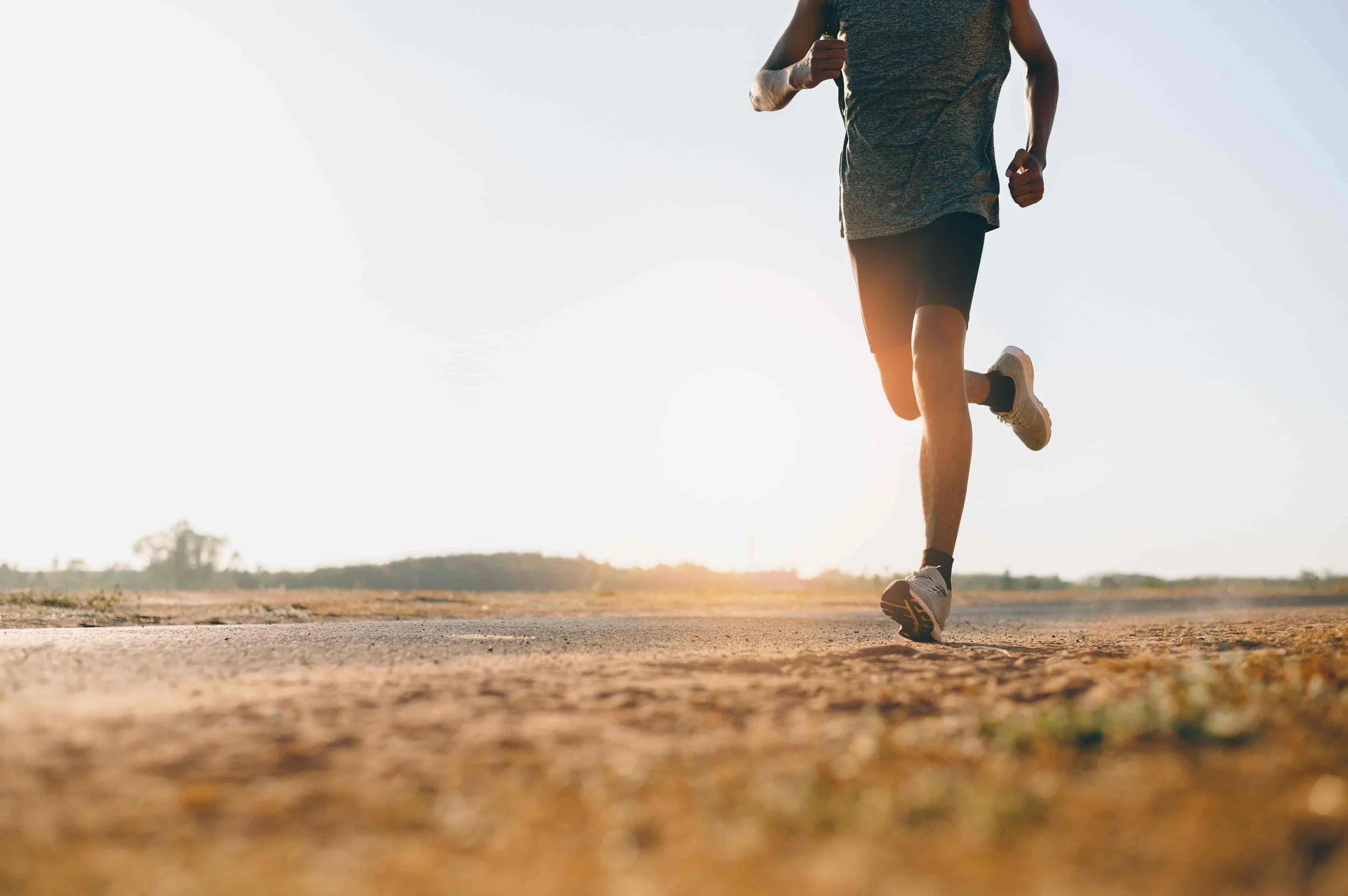An endurance runner going along a dirt road part.