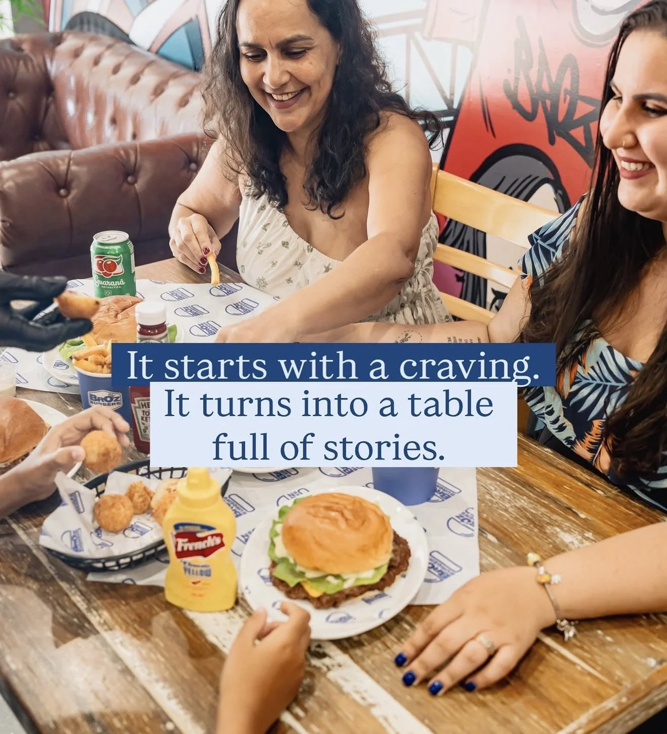 Customers enjoying smash burgers, fried chicken bites and loaded fries at BrOz Burgers Sydney in a casual dine-in setting.